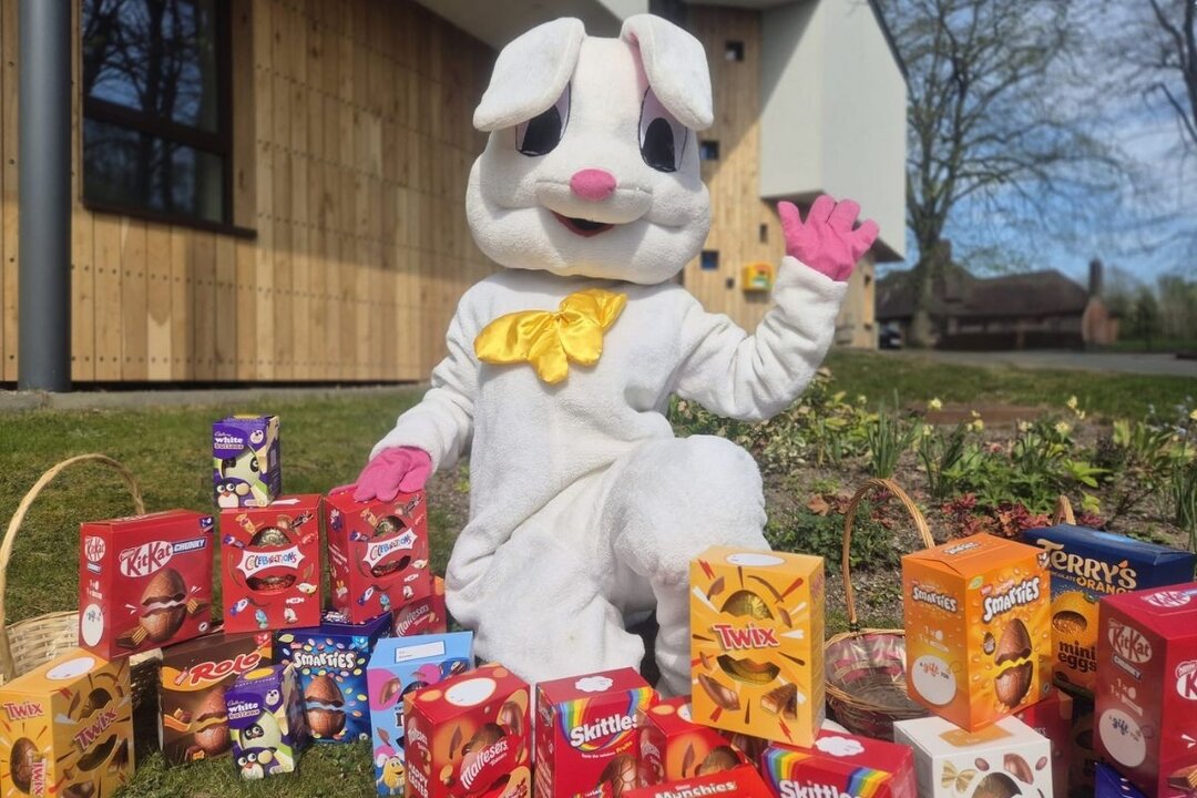 Easter Bunny surrounded by easter eggs outside a hospice