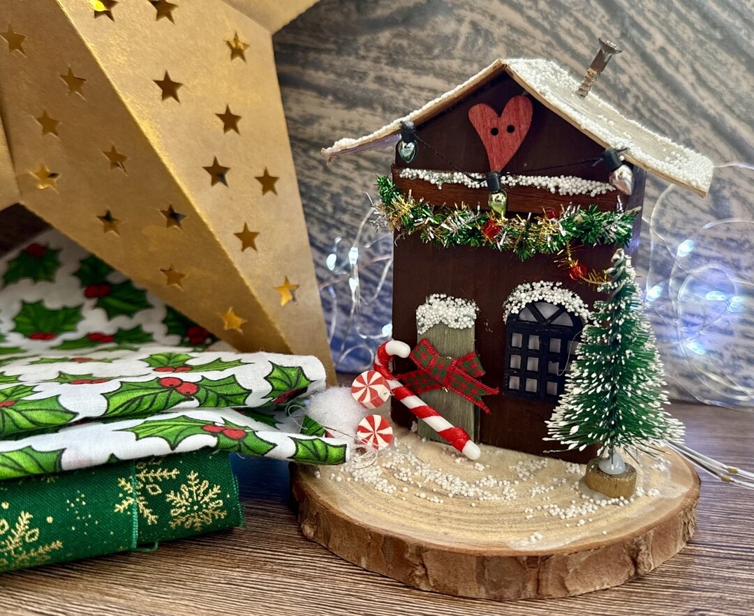 mini crafted christmas house on a christmas background