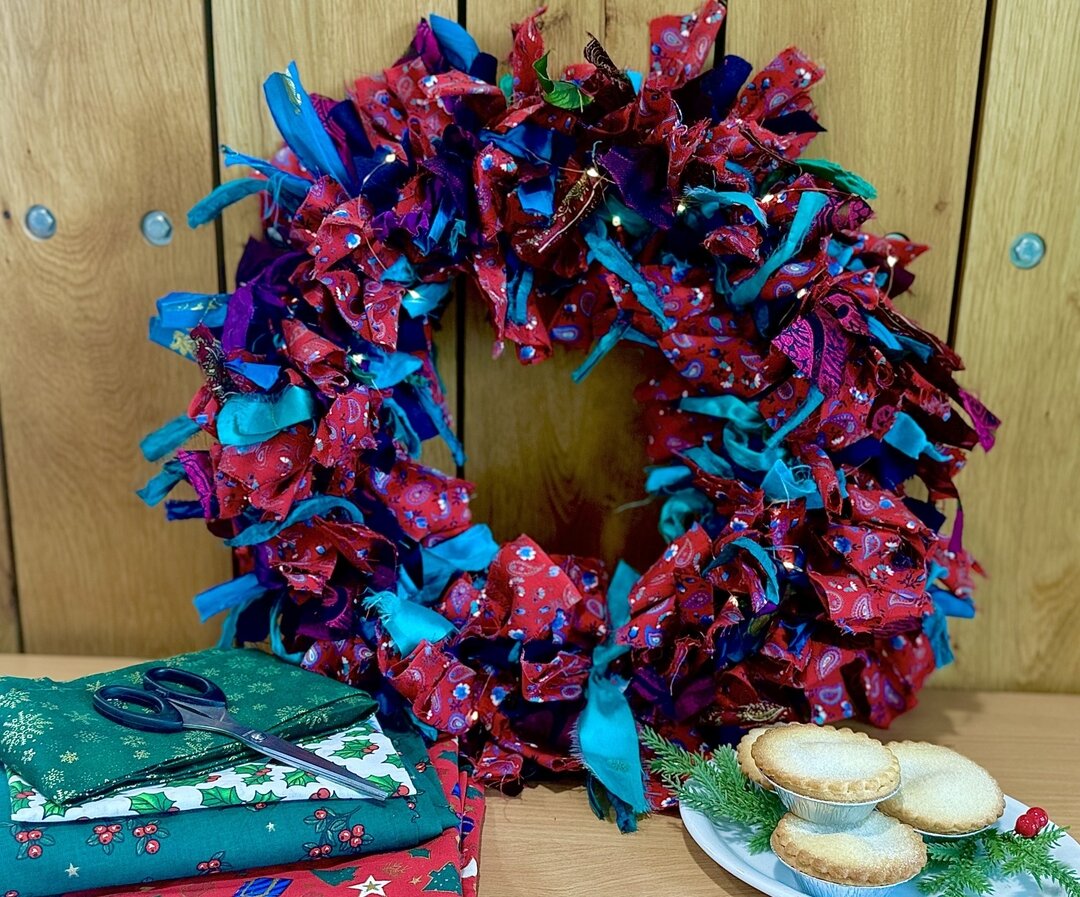 festive wreath on wooden background with mince pies at the side of shot
