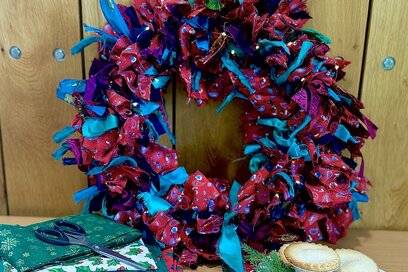 festive wreath on wooden background with mince pies at the side of shot