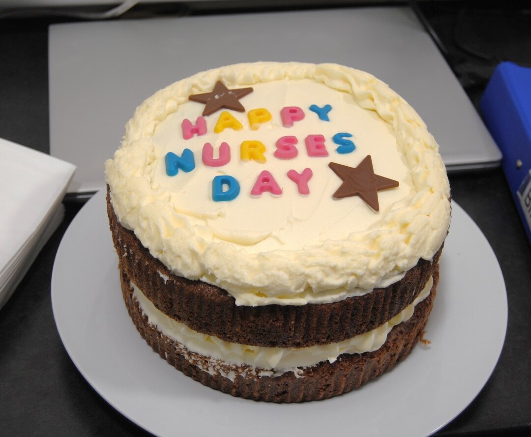 close up of cake saying 'happy nurses day' with stars on