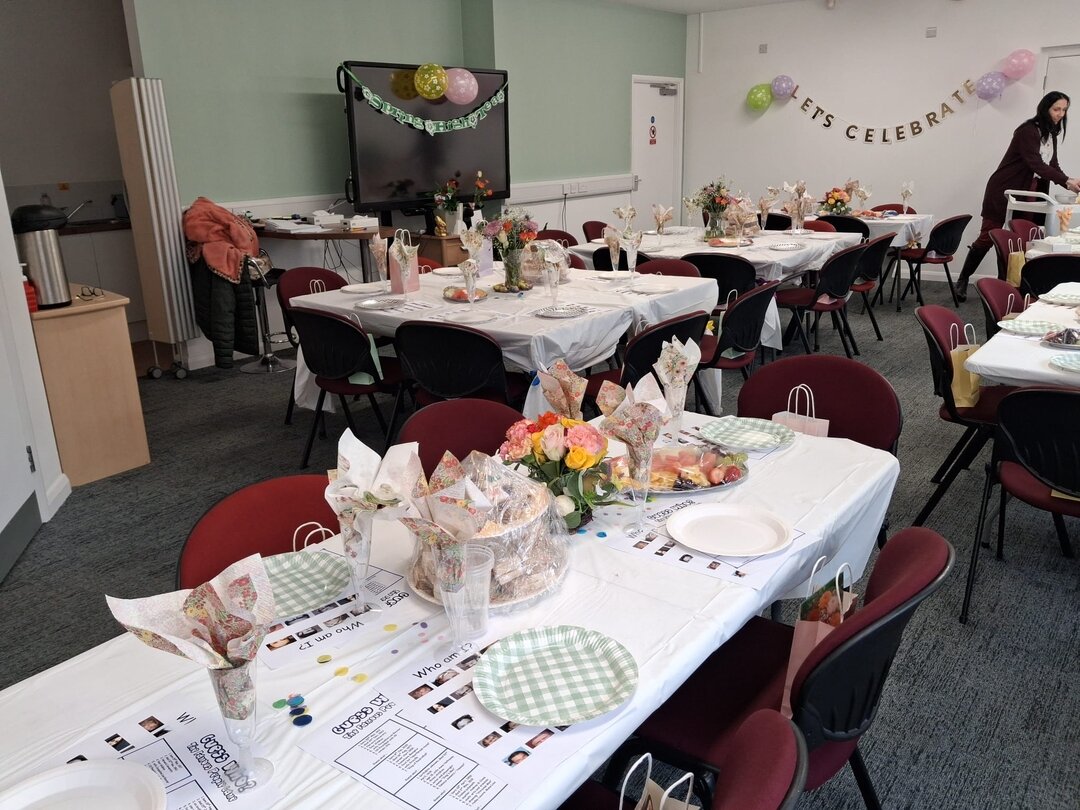 tables with flowers and plates at the spring high tea event