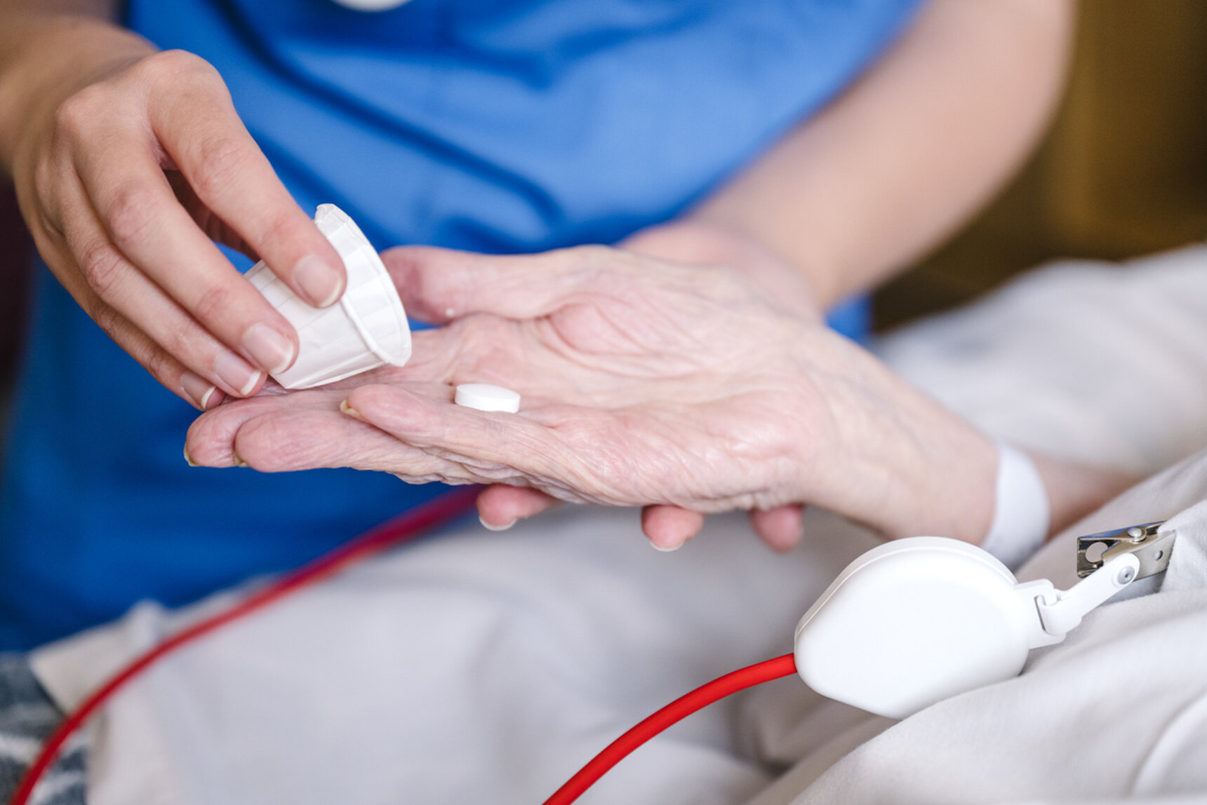 Nurse handing patient medication
